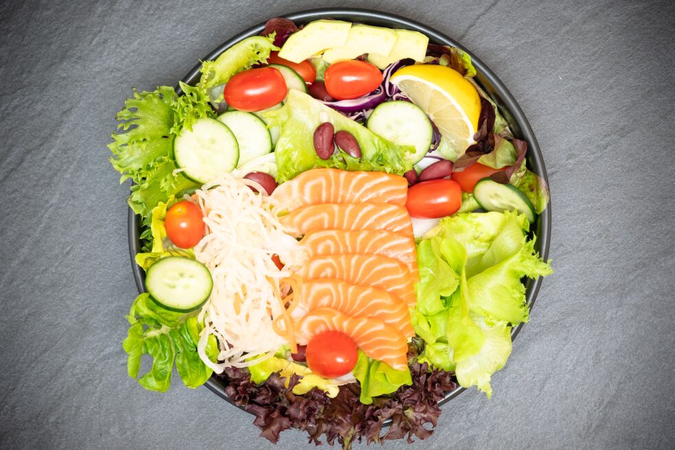 Delicious salad with salmon in the proper diet menu for weight loss